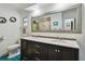 Bright bathroom boasts a double sink vanity with a large framed mirror and blue tiled floors at 5961 36Th Ave N, St Petersburg, FL 33710