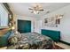 Comfortable bedroom features a tropical floral theme, accent wall, and double door closet at 5961 36Th Ave N, St Petersburg, FL 33710