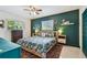 A well-decorated bedroom with a green accent wall, stylish furnishings, and natural light at 5961 36Th Ave N, St Petersburg, FL 33710
