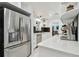 A well-lit kitchen showcasing stainless steel refrigerator, white cabinets, and bright quartz countertops at 5961 36Th Ave N, St Petersburg, FL 33710