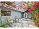 Charming outdoor seating area with beautiful bougainvillea-covered pergola and palm tree rug at 5961 36Th Ave N, St Petersburg, FL 33710