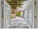 Inviting outdoor patio space with an overhead pergola and bougainvillea at 5961 36Th Ave N, St Petersburg, FL 33710