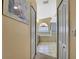 Hallway view into bright bathroom featuring a garden tub and tile flooring at 6121 Piedmont Dr, Spring Hill, FL 34606