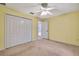 Carpeted bedroom with closet and view of adjacent bathroom with walk-in shower at 6121 Piedmont Dr, Spring Hill, FL 34606