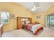 Bright bedroom with a queen-sized bed, ceiling fan, and sliding glass doors at 6121 Piedmont Dr, Spring Hill, FL 34606