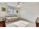 Bright bedroom featuring a window, fan, and closet at 6121 Piedmont Dr, Spring Hill, FL 34606
