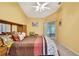 Bright bedroom with a sliding glass door, ceiling fan, and neutral carpet at 6121 Piedmont Dr, Spring Hill, FL 34606