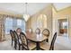 Spacious dining room featuring a large table, elegant chandelier and neutral decor at 6121 Piedmont Dr, Spring Hill, FL 34606