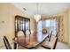 Spacious dining room featuring a large table, elegant chandelier and neutral decor at 6121 Piedmont Dr, Spring Hill, FL 34606