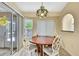 Dining room features a round table with seating for four, and a sliding glass door at 6121 Piedmont Dr, Spring Hill, FL 34606