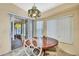 Dining room features round table, seating for four, and sliding glass doors to the patio at 6121 Piedmont Dr, Spring Hill, FL 34606