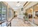 Florida room features tile flooring, ceiling fan, and multiple sliding doors for bright natural light at 6121 Piedmont Dr, Spring Hill, FL 34606
