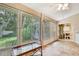 This enclosed Florida room features tile flooring, large windows and access to outside and kitchen at 6121 Piedmont Dr, Spring Hill, FL 34606