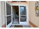 Inviting front entrance featuring a decorative storm door and 'HOME' welcome sign at 6121 Piedmont Dr, Spring Hill, FL 34606