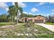 Landscaped home exterior with a two-car garage and well-maintained lawn at 6121 Piedmont Dr, Spring Hill, FL 34606
