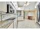 Well-lit kitchen with granite countertops, white appliances, and dining nook at 6121 Piedmont Dr, Spring Hill, FL 34606