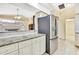Spacious kitchen with stainless steel refrigerator and granite countertops at 6121 Piedmont Dr, Spring Hill, FL 34606