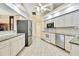 Bright kitchen features white cabinets, stainless steel appliances, and granite countertops at 6121 Piedmont Dr, Spring Hill, FL 34606