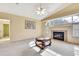 Bright living room with a fireplace, large arched window, and vaulted ceiling at 6121 Piedmont Dr, Spring Hill, FL 34606