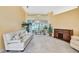 Bright living room with large sliding doors, neutral decor, and tiled floors at 6121 Piedmont Dr, Spring Hill, FL 34606