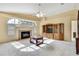 Spacious living room featuring a fireplace, large arched window and built-in shelving at 6121 Piedmont Dr, Spring Hill, FL 34606