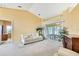 Bright living room with large sliding doors, neutral decor, and tiled floors at 6121 Piedmont Dr, Spring Hill, FL 34606
