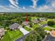 Aerial view showcases a home with a large driveway, lush lawn and mature landscaping at 6204 Rockross Ave, New Port Richey, FL 34655