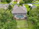 Aerial view of a home featuring a screened-in pool, fenced yard, and mature trees at 6204 Rockross Ave, New Port Richey, FL 34655