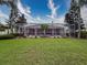 This backyard boasts a large screened-in pool with ample seating, a well-manicured lawn and mature landscaping at 6204 Rockross Ave, New Port Richey, FL 34655