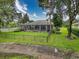 This home features a screened-in pool, a fenced-in backyard, and lush landscaping at 6204 Rockross Ave, New Port Richey, FL 34655
