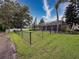 The fenced-in backyard features a screened-in pool and is surrounded by beautiful trees and landscaping at 6204 Rockross Ave, New Port Richey, FL 34655
