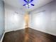 View of a bedroom with dark hardwood floors and white trim at 6204 Rockross Ave, New Port Richey, FL 34655