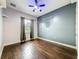 Bedroom with dark hardwood floors and ceiling fan with a view to the outdoors at 6204 Rockross Ave, New Port Richey, FL 34655