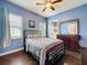 Bedroom featuring hardwood floors, two windows, and view to bathroom at 6204 Rockross Ave, New Port Richey, FL 34655