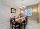 This dining room features a decorative chandelier, neutral colors, and ample natural light at 6204 Rockross Ave, New Port Richey, FL 34655