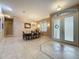 Dining room with a chandelier, neutral colors, and tile flooring that provides an elegant space for meals at 6204 Rockross Ave, New Port Richey, FL 34655