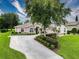 Charming single-story home featuring a lush landscaped yard, mature trees, and a well-maintained lawn on a sunny day at 6204 Rockross Ave, New Port Richey, FL 34655