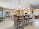 Open-concept kitchen with breakfast bar seating and views of the dining area, blending style and function at 6204 Rockross Ave, New Port Richey, FL 34655
