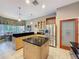 Modern kitchen featuring a center island, stainless steel appliances, and seamless flow to dining and pantry at 6204 Rockross Ave, New Port Richey, FL 34655