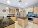Spacious kitchen with stainless steel appliances, granite countertops, and a functional center island at 6204 Rockross Ave, New Port Richey, FL 34655