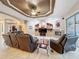 The open-concept living room includes a tray ceiling, built-in shelves, a fireplace, and access to an outdoor area at 6204 Rockross Ave, New Port Richey, FL 34655