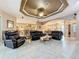 Spacious living room boasts a tray ceiling, neutral colors, and seamless flow into the kitchen and dining areas at 6204 Rockross Ave, New Port Richey, FL 34655