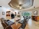 The spacious living room features a fireplace and sliding glass doors opening to a screened outdoor area at 6204 Rockross Ave, New Port Richey, FL 34655
