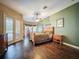 Cozy primary bedroom features hardwood floors, a ceiling fan, and lots of natural light at 6204 Rockross Ave, New Port Richey, FL 34655