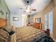 Bright primary bedroom with ceiling fan, dresser, and large windows at 6204 Rockross Ave, New Port Richey, FL 34655