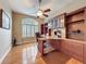 This home office has custom built-in shelving, hardwood floors, and a large window for natural light at 6204 Rockross Ave, New Port Richey, FL 34655