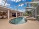 Beautiful backyard pool and spa combo under screened enclosure with ample patio space at 6204 Rockross Ave, New Port Richey, FL 34655