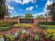 Beautiful brick Riverside Estates neighborhood entrance sign surrounded by colorful landscaping against a vibrant blue sky backdrop at 6204 Rockross Ave, New Port Richey, FL 34655
