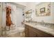 Charming bathroom features granite countertop, unique mirror with shell decorations and shower with themed curtain at 6503 Santiago Ct, Apollo Beach, FL 33572