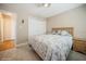 Comfortable bedroom featuring light-colored wooden floors, ceiling fan, double door closet and tan walls at 6503 Santiago Ct, Apollo Beach, FL 33572